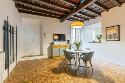 a kitchen and dining room with a table and chairs at Rome As You Feel - Santa Margherita Design Apartment in Rome