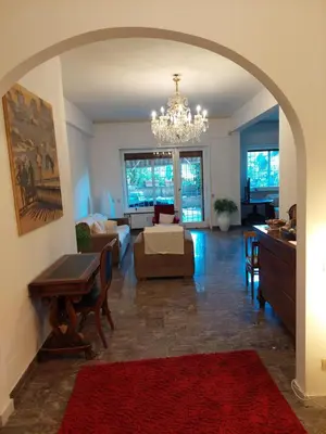 a living room with a chandelier and a living room at Appartamento con giardino in zona Ponte Milvio e Stadio Olimpico in Rome