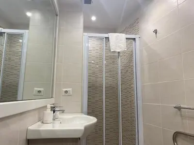 a bathroom with a sink and a shower at Residenza Bernini in Rome