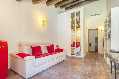 a living room with a white couch and red pillows at ANTICA DIMORA FARNESE in Rome