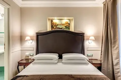 a bedroom with a large bed with two pillows at Aurelius Ponte Sant'Angelo in Rome