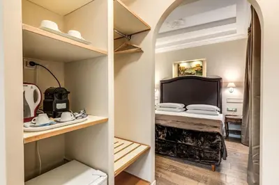 a small room with a bed and a sink at Aurelius Ponte Sant'Angelo in Rome