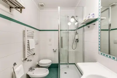 a bathroom with a toilet and a glass shower at Aurelius Ponte Sant'Angelo in Rome