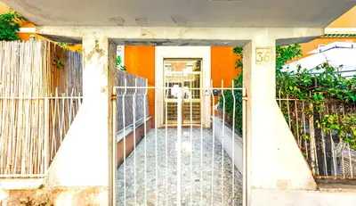 an entrance to a house with a gate at Hostly - Family Home Stresa in Rome