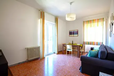 a living room with a couch and a table at Hostly - Family Home Stresa in Rome