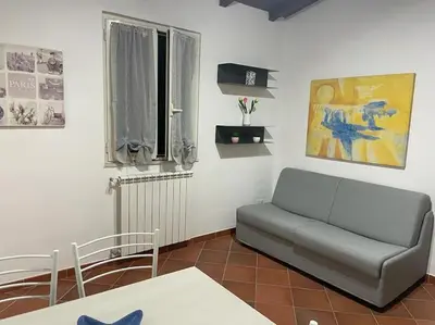 a living room with a couch and a window at Residenza niutta- roma in Rome