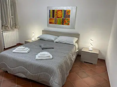 a bedroom with a bed with two towels on it at Residenza niutta- roma in Rome
