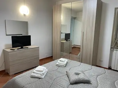 a bedroom with a bed and a tv and a mirror at Residenza niutta- roma in Rome