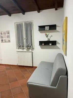 a living room with a couch and a window at Residenza niutta- roma in Rome