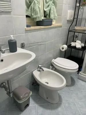 a bathroom with a toilet and a sink at Residenza niutta- roma in Rome