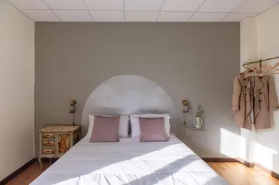 a bedroom with a large white bed with pink pillows at iFlat Trevi Fountain's roomy&friendly apartment in Rome