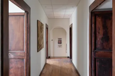 an empty corridor with two doors and a hallway with a hallway at iFlat Trevi Fountain's roomy&friendly apartment in Rome