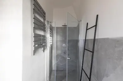 a shower with a glass door in a bathroom at iFlat Trevi Fountain's roomy&friendly apartment in Rome