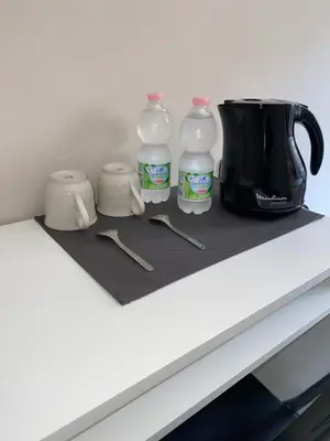 a counter with three bottles of water and a coffee maker at ROMA PARADISO GUEST HOUSE in Rome