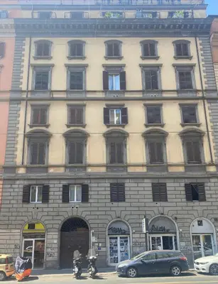 a large building with cars parked in front of it at ROMA PARADISO GUEST HOUSE in Rome