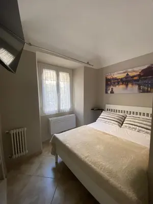 a bedroom with a large bed and two windows at ROMA PARADISO GUEST HOUSE in Rome