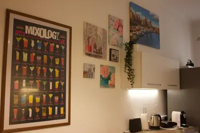 a kitchen with a poster on the wall at A 200Metri Dal Vaticano, 2 Camere Da Letto in Rome
