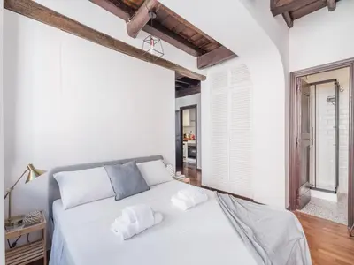 a bedroom with a white bed and a window at The Best Rent - Elegant apartment in Trastevere in Rome