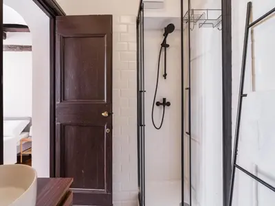 a shower with a wooden door in a bathroom at The Best Rent - Elegant apartment in Trastevere in Rome