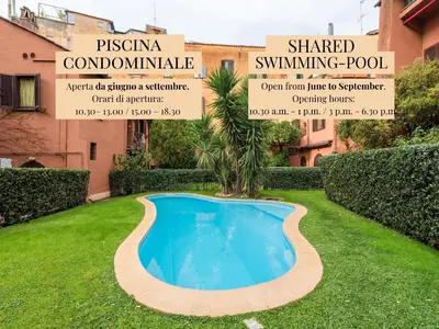 a swimming pool in a yard with a palm tree at The Best Rent - Elegant apartment in Trastevere in Rome
