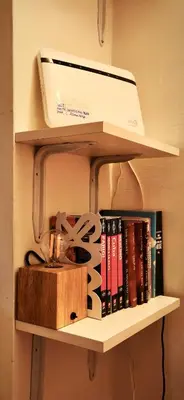 a shelf with books and a printer on it at Lovely studio near the Colosseum in Rome