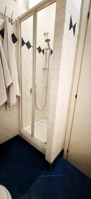 a bathroom with a shower and a toilet at Lovely studio near the Colosseum in Rome