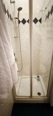 a shower with a glass door in a bathroom at Lovely studio near the Colosseum in Rome