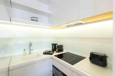 a small white kitchen with a sink and a microwave at Amazing Vista Piazza Venezia in Rome