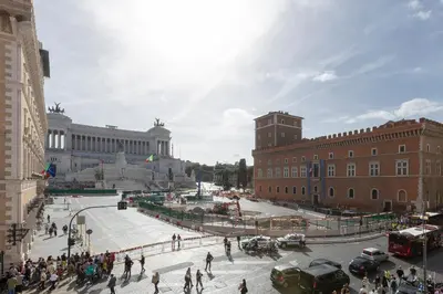 a group of people walking around a city street at Amazing Vista Piazza Venezia in Rome