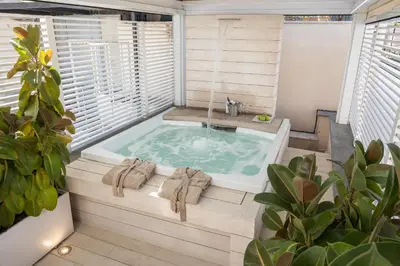 a jacuzzi tub in a room with a window at Amazing 3 Levels Penthouse Piazza Venezia in Rome