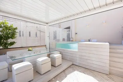 a bathroom with a tub and a swimming pool at Amazing 3 Levels Penthouse Piazza Venezia in Rome