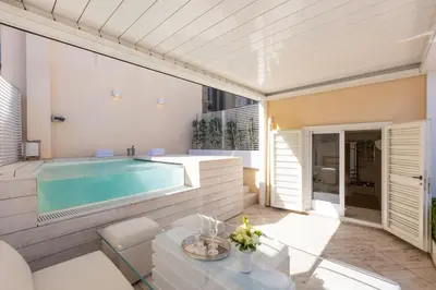 a swimming pool in a patio with a table and chairs at Amazing 3 Levels Penthouse Piazza Venezia in Rome