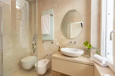 a bathroom with a sink and a toilet and a mirror at Amazing 3 Levels Penthouse Piazza Venezia in Rome