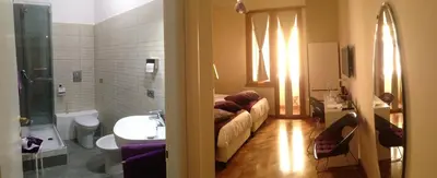 a room with a couch and a sink and a bathroom at L'Appartamento Romano in Rome