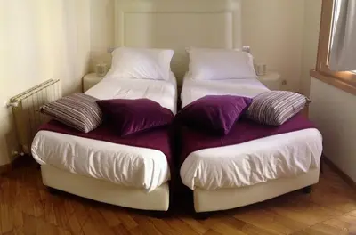 two beds sitting next to each other in a room at L'Appartamento Romano in Rome