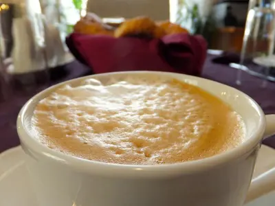 a cup of coffee sitting on a table at L'Appartamento Romano in Rome