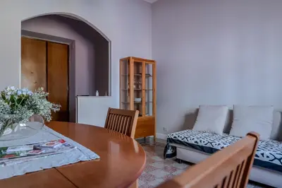 a living room with a table and a couch at La CASA DI SABINA in Rome