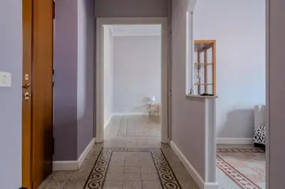 a hallway with an open door to a room with purple walls at La CASA DI SABINA in Rome
