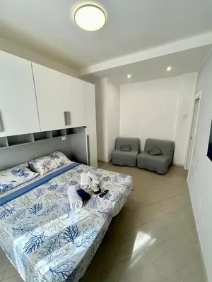 a bedroom with a bed with a stuffed animal on it at Roma Apartment holiday in Rome