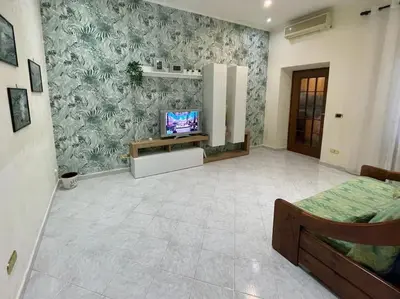 a living room with a tv on a wall at Casa vacanze Pigneto Roma in Rome