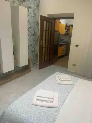 a bathroom with two white towels on a rug at Casa vacanze Pigneto Roma in Rome