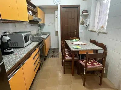 a small kitchen with a table and a microwave at Casa vacanze Pigneto Roma in Rome
