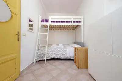 a small room with a bunk bed with a ladder at Piccola Piazza Della Libertà in Rome