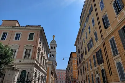 a city street with buildings and a clock tower at Piccola Piazza Della Libertà in Rome