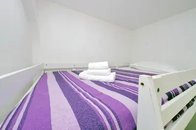 a purple and white bed in a room at Piccola Piazza Della Libertà in Rome