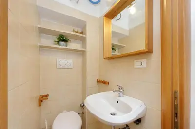 a bathroom with a sink and a toilet and a mirror at Piccola Piazza Della Libertà in Rome