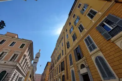 a group of buildings on a city street at Piccola Piazza Della Libertà in Rome