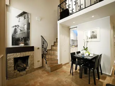 a dining room with a fireplace and a table and chairs at Antiche Residenze Romane - CAMPO DE' FIORI in Rome