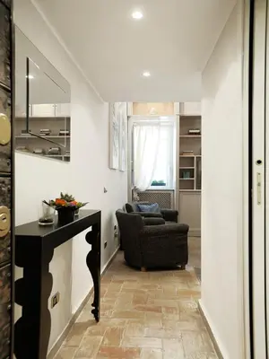 a living room with a table and a chair at Antiche Residenze Romane - CAMPO DE' FIORI in Rome