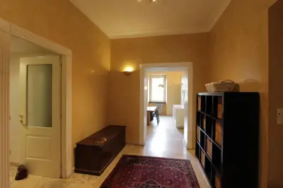 a hallway with a room with a book shelf and a door at Cattaneo Flat in Rome